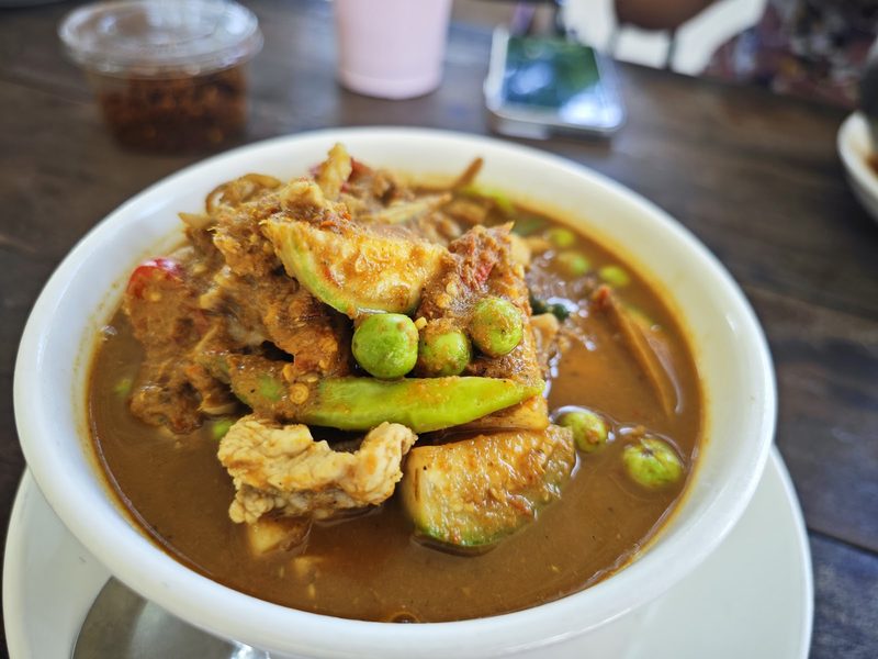 แกงน้ำข้นสีน้ำตาลอมส้ม ใส่มะเขือเปราะและมะเขือพวง